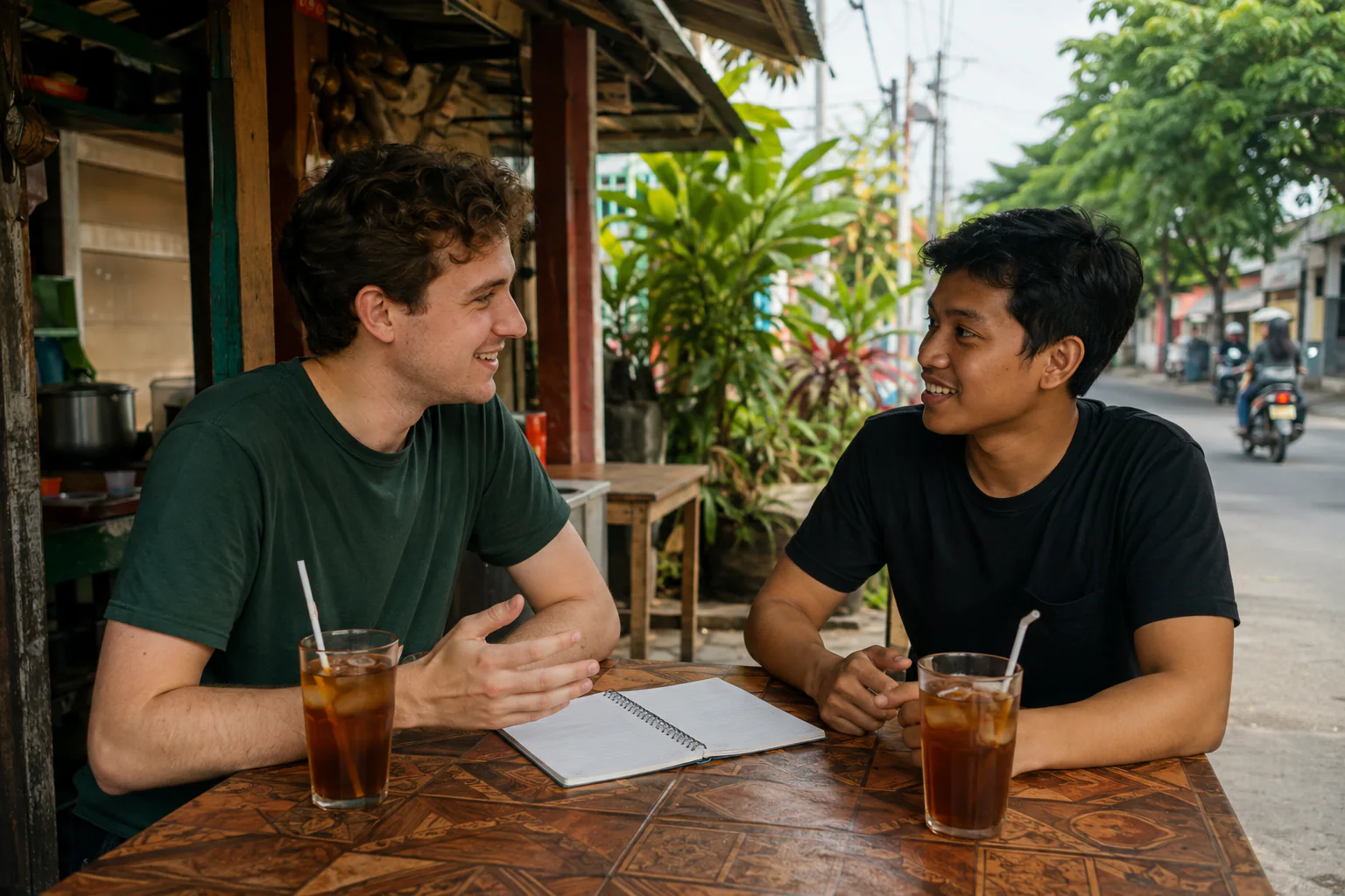 An international student practises everyday Bahasa Indonesia with an Indonesian peer in a welcoming learning space.