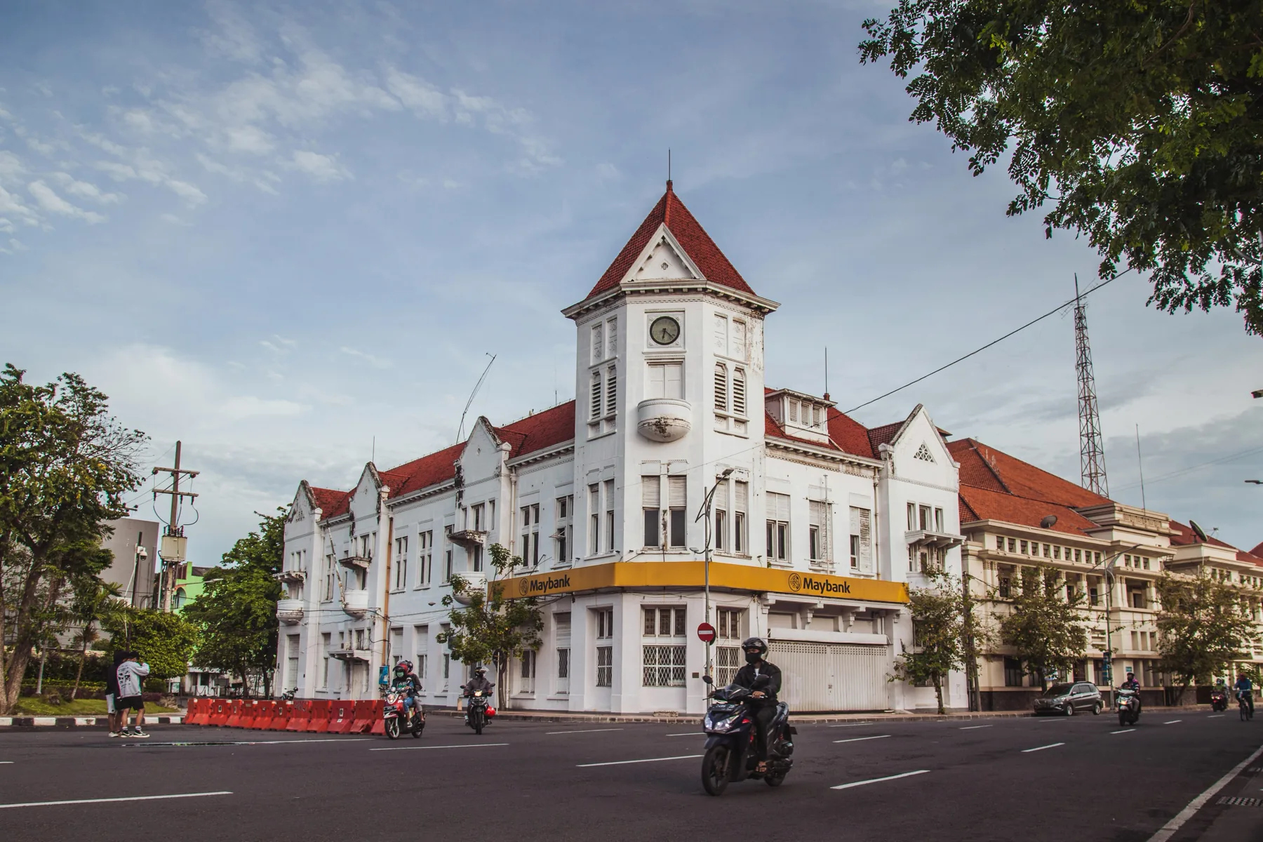 Historic architecture and daily traffic in Surabaya.